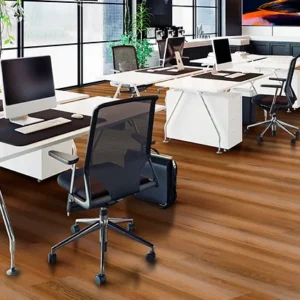 A group of desks with chairs and laptops on top.