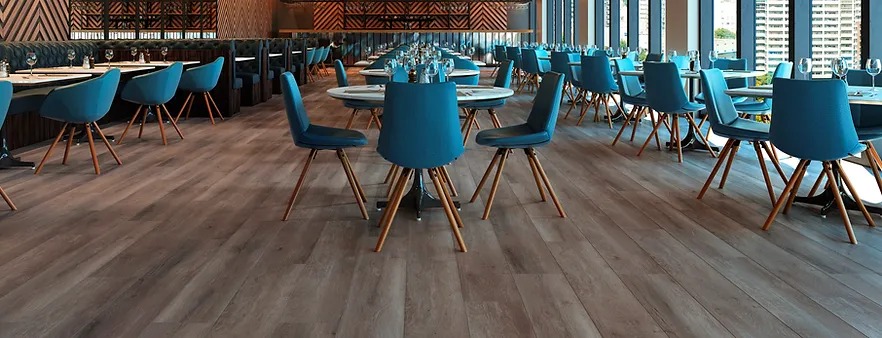 A restaurant with blue chairs and tables in it