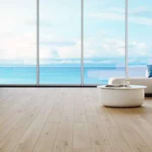 A room with a view of the ocean and a white couch.