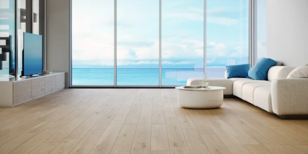 A room with a view of the ocean and a white couch.